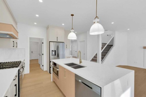 566 Rivercrest View, Cochrane, AB - Indoor Photo Showing Kitchen With Double Sink With Upgraded Kitchen