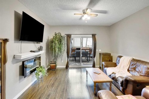 14691 Deer Ridge Drive Se, Calgary, AB - Indoor Photo Showing Living Room With Fireplace