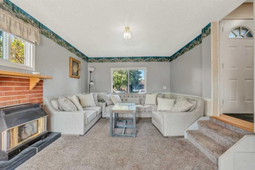 4771 Rundlehorn Drive Ne, Calgary, AB - Indoor Photo Showing Living Room With Fireplace