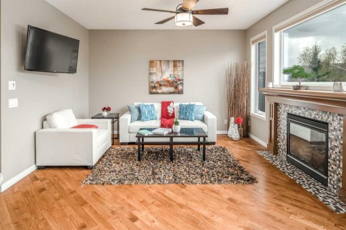 105 Aspen Stone Road Sw, Calgary, AB - Indoor Photo Showing Living Room With Fireplace