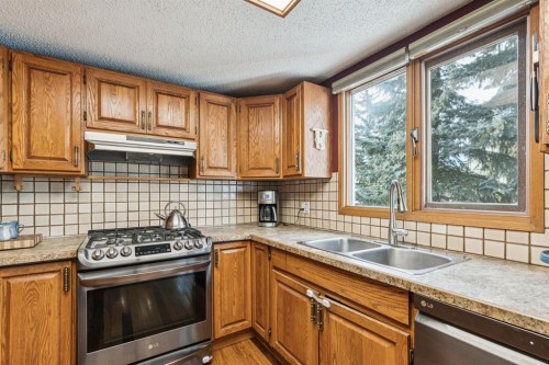 715 Coach Bluff Crescent Sw, Calgary, AB - Indoor Photo Showing Kitchen With Double Sink