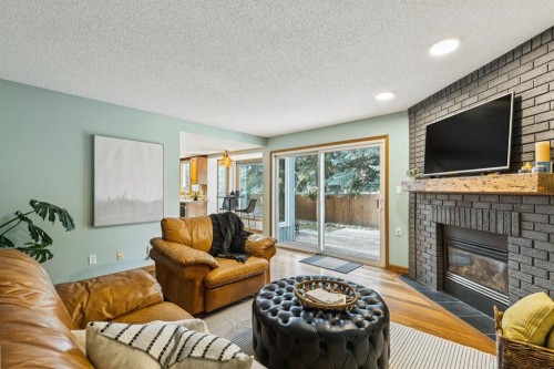 715 Coach Bluff Crescent Sw, Calgary, AB - Indoor Photo Showing Living Room With Fireplace