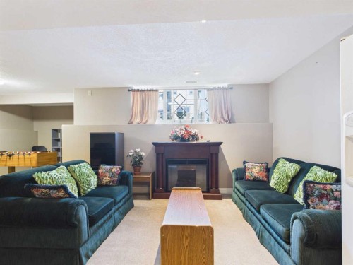 107 Panatella Close Nw, Calgary, AB - Indoor Photo Showing Living Room With Fireplace