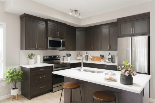 701-250 Fireside View, Cochrane, AB - Indoor Photo Showing Kitchen With Double Sink