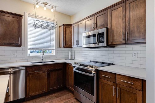 521 Westmount Close, Okotoks, AB - Indoor Photo Showing Kitchen With Upgraded Kitchen