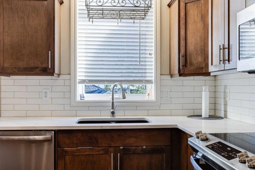 521 Westmount Close, Okotoks, AB - Indoor Photo Showing Kitchen With Double Sink
