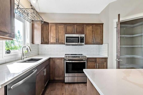 521 Westmount Close, Okotoks, AB - Indoor Photo Showing Kitchen With Double Sink With Upgraded Kitchen
