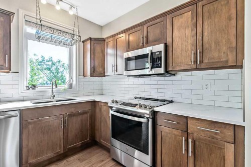 521 Westmount Close, Okotoks, AB - Indoor Photo Showing Kitchen With Upgraded Kitchen