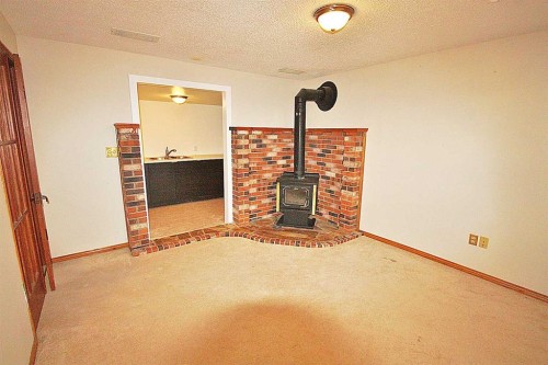 203 Falwood Way Ne, Calgary, AB - Indoor Photo Showing Other Room With Fireplace