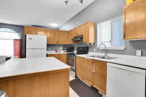 6934 Laguna Way Ne, Calgary, AB - Indoor Photo Showing Kitchen With Double Sink