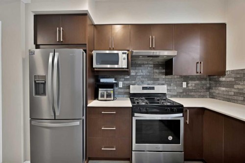 203-350 Redstone Ne, Calgary, AB - Indoor Photo Showing Kitchen With Stainless Steel Kitchen