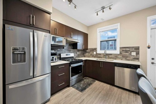 203-350 Redstone Ne, Calgary, AB - Indoor Photo Showing Kitchen With Stainless Steel Kitchen
