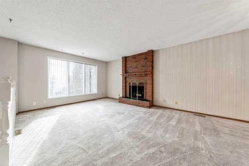 24 Templeson Road Ne, Calgary, AB - Indoor Photo Showing Living Room With Fireplace