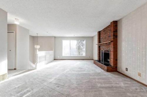 24 Templeson Road Ne, Calgary, AB - Indoor Photo Showing Living Room With Fireplace