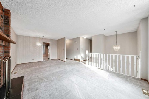 24 Templeson Road Ne, Calgary, AB - Indoor Photo Showing Other Room With Fireplace