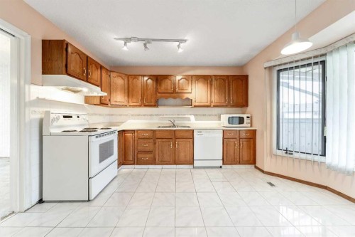 24 Templeson Road Ne, Calgary, AB - Indoor Photo Showing Kitchen With Double Sink