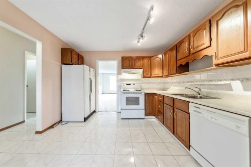 24 Templeson Road Ne, Calgary, AB - Indoor Photo Showing Kitchen With Double Sink