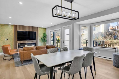 122 Hawkstone Drive Nw, Calgary, AB - Indoor Photo Showing Dining Room With Fireplace