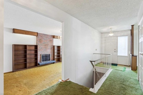 272 Thames Close Nw, Calgary, AB - Indoor Photo Showing Other Room With Fireplace