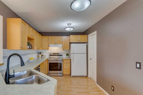 228 Luxstone Place Sw, Airdrie, AB - Indoor Photo Showing Kitchen With Double Sink
