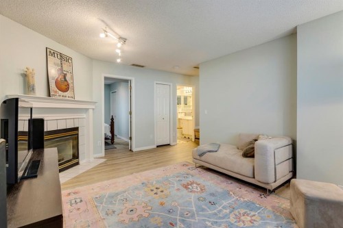 19 Sunlake Gardens Se, Calgary, AB - Indoor Photo Showing Living Room With Fireplace