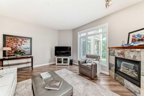 7204-14 Hemlock Crescent Sw, Calgary, AB - Indoor Photo Showing Living Room With Fireplace