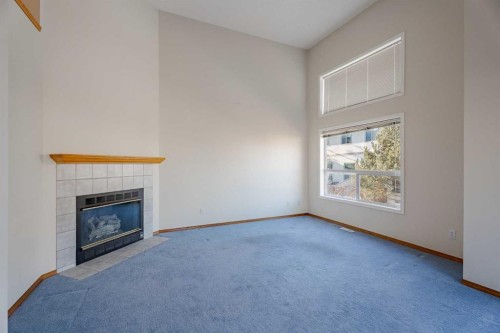 203 Anderson Grove Sw, Calgary, AB - Indoor Photo Showing Other Room With Fireplace
