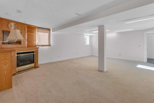 12 Vandoos Villas Nw, Calgary, AB - Indoor With Fireplace