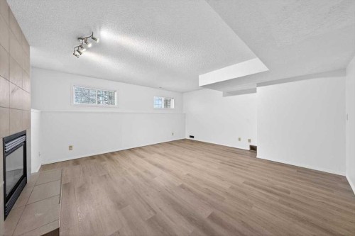 22 Shawinigan Rise Sw, Calgary, AB - Indoor Photo Showing Other Room With Fireplace