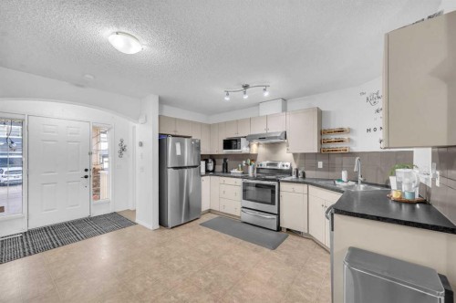 144 Saddlecrest Place Ne, Calgary, AB - Indoor Photo Showing Kitchen With Stainless Steel Kitchen