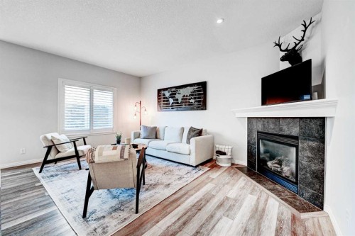195 Chapalina Terrace Se, Calgary, AB - Indoor Photo Showing Living Room With Fireplace
