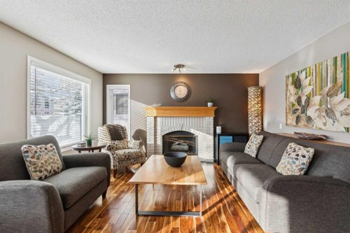33 River Rock Crescent Se, Calgary, AB - Indoor Photo Showing Living Room With Fireplace
