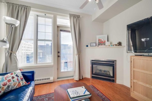 301-208 Holy Cross Lane Sw, Calgary, AB - Indoor Photo Showing Living Room With Fireplace