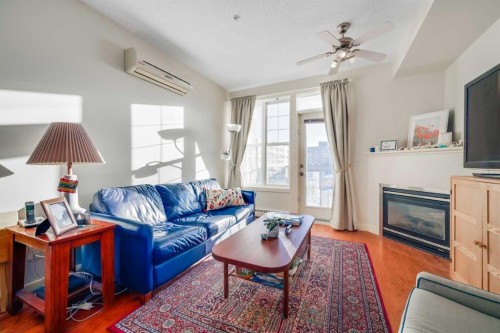 301-208 Holy Cross Lane Sw, Calgary, AB - Indoor Photo Showing Living Room With Fireplace