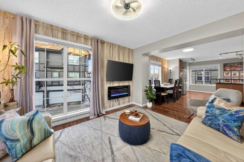 303 New Brighton Villas Se, Calgary, AB - Indoor Photo Showing Living Room With Fireplace