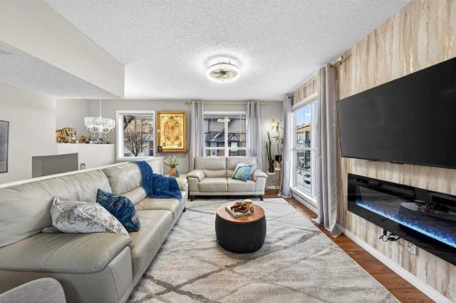 303 New Brighton Villas Se, Calgary, AB - Indoor Photo Showing Living Room With Fireplace