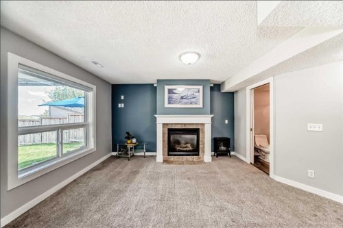 137 Coverton Circle Ne, Calgary, AB - Indoor Photo Showing Other Room With Fireplace