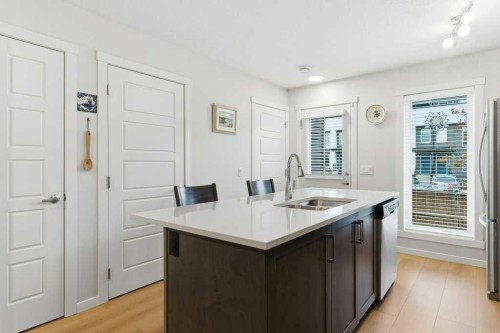 410-338 Seton Circle Se, Calgary, AB - Indoor Photo Showing Kitchen With Double Sink