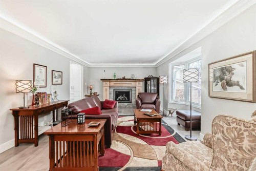 119 Pump Hill Bay Sw, Calgary, AB - Indoor Photo Showing Living Room With Fireplace