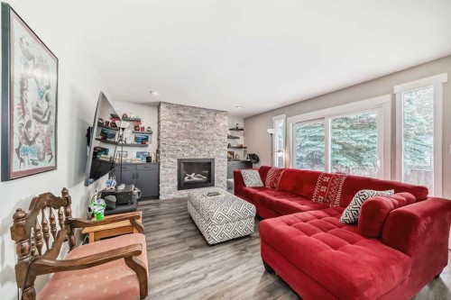 119 Pump Hill Bay Sw, Calgary, AB - Indoor Photo Showing Living Room With Fireplace