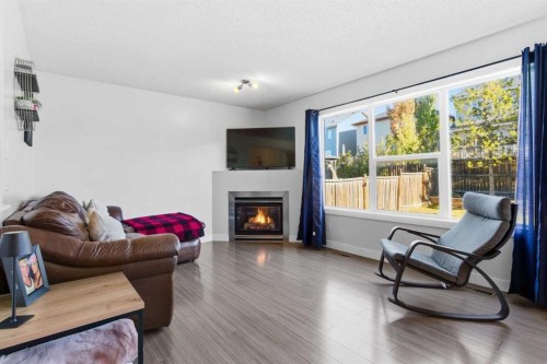 74 Evansbrooke Way Nw, Calgary, AB - Indoor Photo Showing Living Room With Fireplace