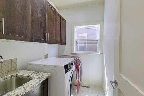 16 Rockcliff Point Nw, Calgary, AB - Indoor Photo Showing Laundry Room