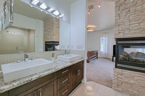 16 Rockcliff Point Nw, Calgary, AB - Indoor Photo Showing Bathroom With Fireplace