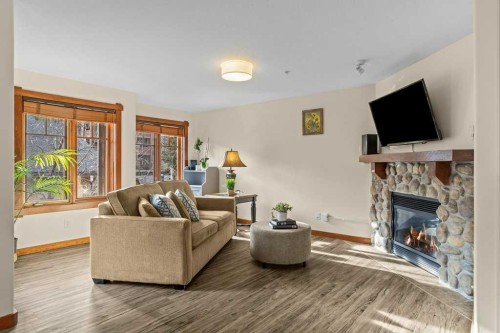 319-170 Crossbow Place, Canmore, AB - Indoor Photo Showing Living Room With Fireplace