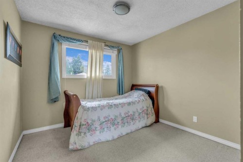 403 Queen Alexandra Way Se, Calgary, AB - Indoor Photo Showing Bedroom