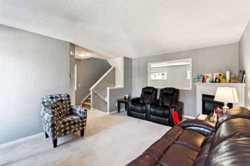 22 Country Hills Cove Nw, Calgary, AB - Indoor Photo Showing Living Room With Fireplace