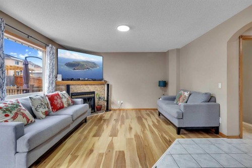 710 Coral Springs Boulevard Ne, Calgary, AB - Indoor Photo Showing Living Room With Fireplace