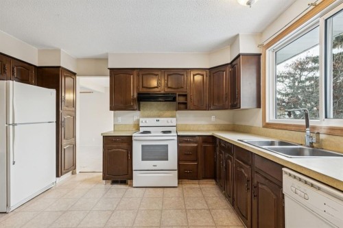 219 Silvercreek Close Nw, Calgary, AB - Indoor Photo Showing Kitchen With Double Sink