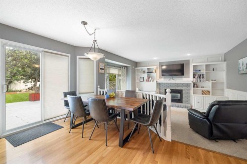 156 Woodfield Road Sw, Calgary, AB - Indoor Photo Showing Dining Room With Fireplace