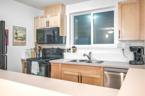 205-2440 34 Avenue Sw, Calgary, AB - Indoor Photo Showing Kitchen With Double Sink
